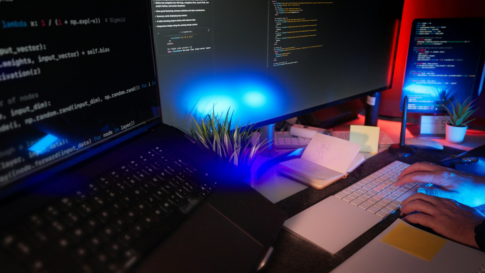 Developer working at a desk with several monitors displaying code